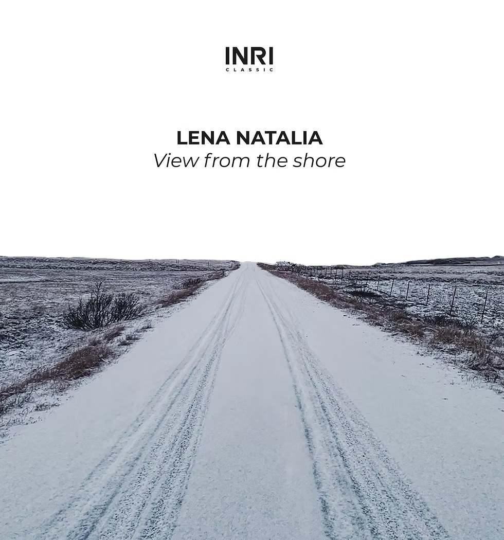 Snow-covered rural road stretching into horizon, flanked by barren winter fields.